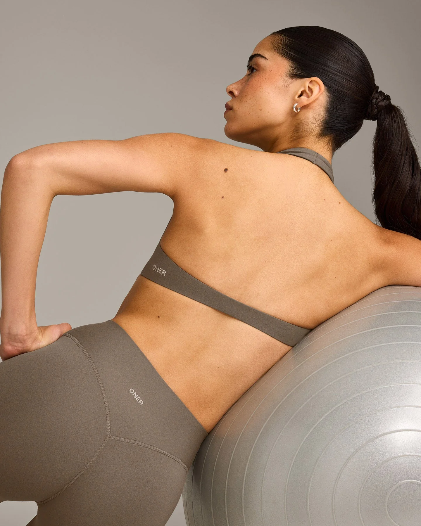 SoftMotion™ Minimal Halter Neck Bralette with Grey Logo | Moss Brown - Image 5